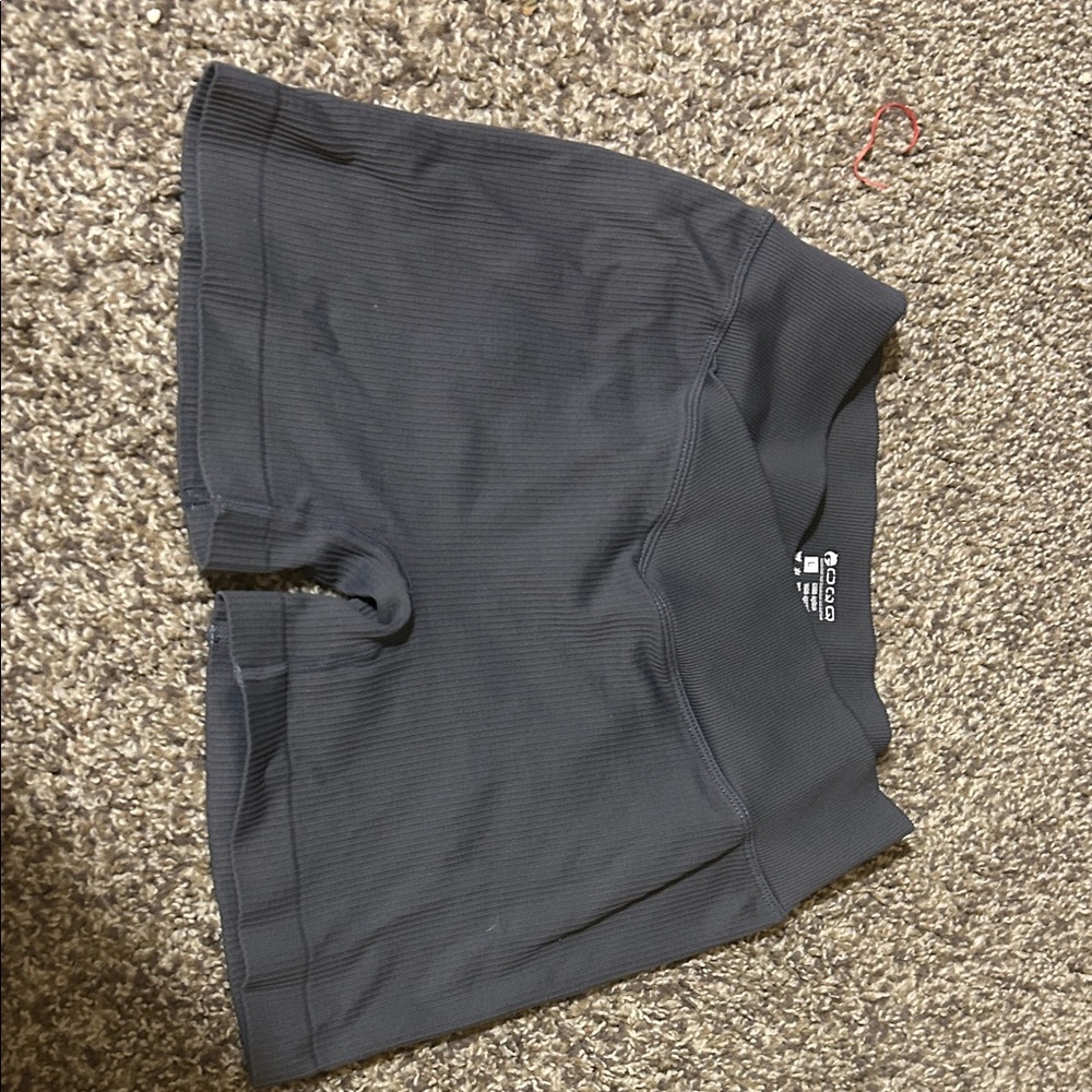 Gray spandex, really nice material, the label says large but fits like a medium